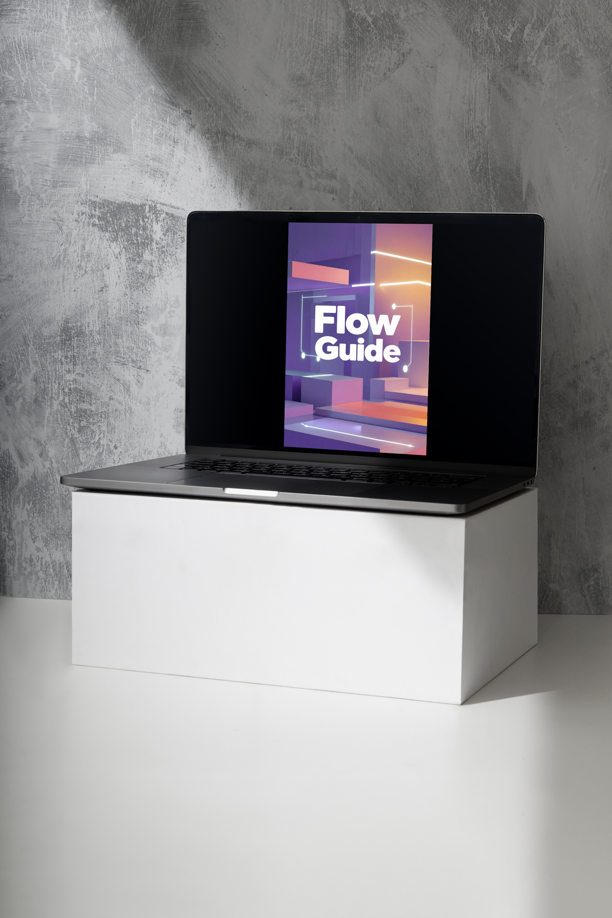 An open black laptop sits on a white pedestal against a textured gray wall, with a colorful screen displaying the words 'Flow Guide'.
